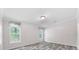 Minimalist bedroom featuring two windows and grey wood floors at 10215 Poplar St, New Port Richey, FL 34654