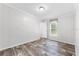 Simple bedroom with neutral walls, clean lines, and a window at 10215 Poplar St, New Port Richey, FL 34654