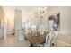 Bright dining room with a rustic wooden table and white chairs at 13837 Messina Loop # 204, Bradenton, FL 34211