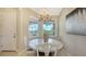 Round dining table with marble top and white chairs at 13837 Messina Loop # 204, Bradenton, FL 34211