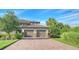 Two-car garage with paver driveway and manicured landscaping at 13837 Messina Loop # 204, Bradenton, FL 34211