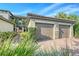 Two-car garage with paver driveway; lush landscaping surrounds home at 13837 Messina Loop # 204, Bradenton, FL 34211