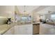 Open kitchen with granite island and stainless steel appliances at 13837 Messina Loop # 204, Bradenton, FL 34211