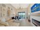 Elegant living room with fireplace, chandelier, and access to balcony at 13837 Messina Loop # 204, Bradenton, FL 34211