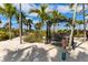 Peaceful seating area with a swing bench near palm trees at 13837 Messina Loop # 204, Bradenton, FL 34211