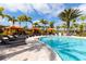 Relaxing pool area with lounge chairs and palm trees at 13837 Messina Loop # 204, Bradenton, FL 34211