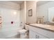 Clean bathroom with white vanity, tub shower combo and granite countertop at 24692 Rio Villa Lakes Cir, Punta Gorda, FL 33950