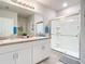 Bathroom with double vanity, large mirror and shower at 24692 Rio Villa Lakes Cir, Punta Gorda, FL 33950