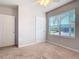 Spacious bedroom with carpeted floor, large window, and double door closet at 24692 Rio Villa Lakes Cir, Punta Gorda, FL 33950