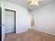 Bedroom with carpeted floor, ceiling fan and access to bathroom at 24692 Rio Villa Lakes Cir, Punta Gorda, FL 33950