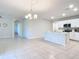 Open dining area with light tile flooring and kitchen island at 24692 Rio Villa Lakes Cir, Punta Gorda, FL 33950
