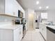 Modern kitchen with white cabinets, stainless steel appliances, and quartz countertops at 24692 Rio Villa Lakes Cir, Punta Gorda, FL 33950