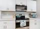 Close-up of kitchen range and microwave at 24692 Rio Villa Lakes Cir, Punta Gorda, FL 33950
