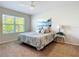 Main bedroom with large bed, window, and ceiling fan at 24692 Rio Villa Lakes Cir, Punta Gorda, FL 33950