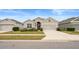 Tan two-story house with a two-car garage at 813 Old Windsor Way, Spring Hill, FL 34609