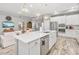 Bright kitchen with white cabinets, stainless steel appliances, and a large island at 813 Old Windsor Way, Spring Hill, FL 34609