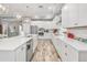 Modern kitchen with white cabinets, stainless steel appliances, and tile flooring at 813 Old Windsor Way, Spring Hill, FL 34609