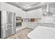 Modern kitchen with white cabinets, stainless steel appliances and a large island at 813 Old Windsor Way, Spring Hill, FL 34609