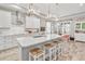 Open concept kitchen with white cabinets, an island, and stainless steel appliances at 813 Old Windsor Way, Spring Hill, FL 34609