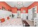 Main bedroom with coral walls, white furniture, and access to the bathroom at 813 Old Windsor Way, Spring Hill, FL 34609