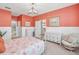 Relaxing main bedroom with coral walls and a view into the bathroom at 813 Old Windsor Way, Spring Hill, FL 34609