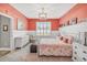 Spacious main bedroom with coral walls, white accents, and a comfortable bed at 813 Old Windsor Way, Spring Hill, FL 34609