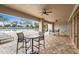 Covered patio area with tables and chairs overlooking the community pool at 813 Old Windsor Way, Spring Hill, FL 34609