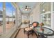 Screened porch with wicker furniture and view of backyard at 813 Old Windsor Way, Spring Hill, FL 34609