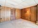 Spacious basement room with wood paneling and neutral carpeting at 8701 Gulf Blvd, St Pete Beach, FL 33706