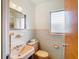 Bathroom with peach sink, toilet and tiled walls at 8701 Gulf Blvd, St Pete Beach, FL 33706