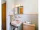 Bathroom with peach sink and tiled walls at 8701 Gulf Blvd, St Pete Beach, FL 33706