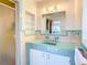 Retro bathroom with mint green tile and built-in vanity at 8701 Gulf Blvd, St Pete Beach, FL 33706