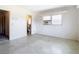 Bedroom with window, terrazzo floor, and bathroom access at 8701 Gulf Blvd, St Pete Beach, FL 33706