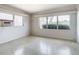 Well-lit bedroom with terrazzo floor and window with blinds at 8701 Gulf Blvd, St Pete Beach, FL 33706