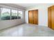 Bright bedroom with terrazzo floor and large window at 8701 Gulf Blvd, St Pete Beach, FL 33706