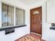 A brown front door with a glass window and tiled entryway at 8701 Gulf Blvd, St Pete Beach, FL 33706