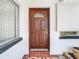 Attractive brown front door entry to a single-story home at 8701 Gulf Blvd, St Pete Beach, FL 33706