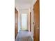 A long hallway with wood doors leading to bedrooms at 8701 Gulf Blvd, St Pete Beach, FL 33706