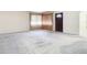 A large living area with grey carpet and neutral walls at 8701 Gulf Blvd, St Pete Beach, FL 33706