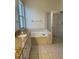 Bathroom with granite vanity, shower, and garden tub at 1652 Open Field Loop, Brandon, FL 33510