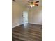 Bright bedroom with wood-look floors and ceiling fan at 1652 Open Field Loop, Brandon, FL 33510