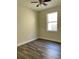 Well-lit bedroom with wood-look floors and ceiling fan at 1652 Open Field Loop, Brandon, FL 33510