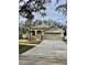 One-story house with a two-car garage and palm tree at 1652 Open Field Loop, Brandon, FL 33510