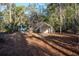Wooded backyard with storage shed and canopy at 11317 Salina St, Brooksville, FL 34614