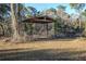 Open-air carport structure in wooded area at 11317 Salina St, Brooksville, FL 34614
