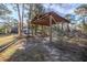 Rustic wooden carport with gated enclosure at 11317 Salina St, Brooksville, FL 34614
