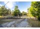 Gravel driveway leading to a rustic home at 11317 Salina St, Brooksville, FL 34614