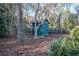 Dark-green shed nestled amongst trees at 11317 Salina St, Brooksville, FL 34614
