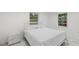 Bright bedroom with white bed and marble nightstand at 1212 59Th S St, Gulfport, FL 33707