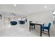 Modern dining area with marble floors and blue velvet chairs at 1212 59Th S St, Gulfport, FL 33707